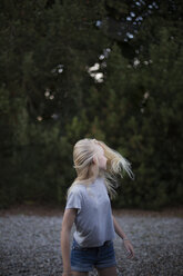 Girl standing outdoors in Ornahusen, Sweden - FOLF10263