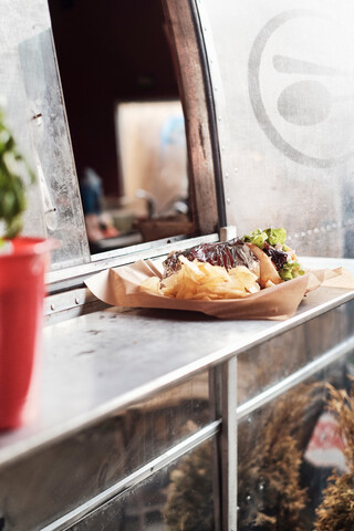 Food served through window of camper van food truck stock photo