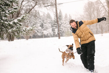 Man and pet dog playing with toy - ISF20326