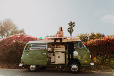 Man on van road trip with his surfboard, Ventura, California, US - ISF20374