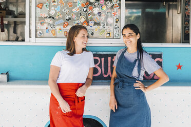 Confident young multi-ethnic female owners standing against food truck - MASF10983