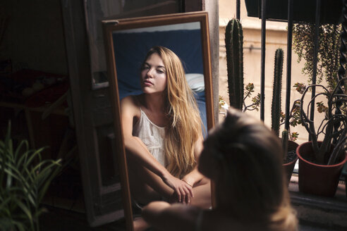 Mirror image of young woman watching herself - LOTF00051