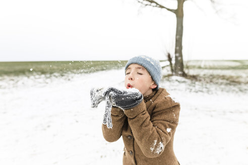 Boy playing with snow in winter - KMKF00705