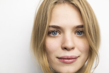 Porträt einer blonden jungen Frau vor weißem Hintergrund - VGF00199