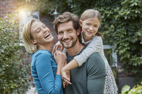 Portrait of happy family in garden of their home stock photo