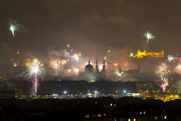 Germany, Wuerzburg, fireworks over cityscape at New Year's Eve - NDF00857