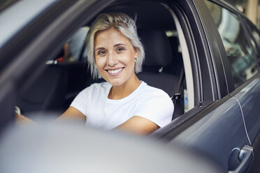 Young woman sitting in her car - PNEF01145