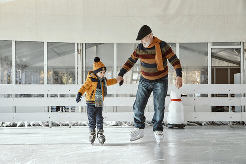 Grandfather and grandson on the ice rink, ice skating - ZEDF01807