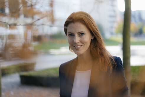 Portrait of smiling businesswoman outdoors in the city - JOSF02914