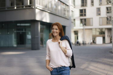 Smiling businesswoman outdoors in the city - JOSF02916