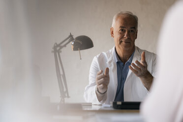 Senior doctor talking to female patient in medical practice - JOSF02929