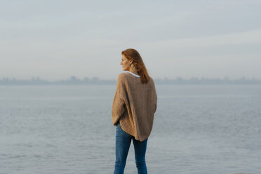 Germany, Hamburg, woman standing at the Elbe shore - JOSF02982