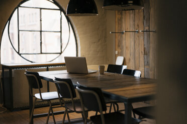 Laptop on table in wooden conference room - JOSF02990