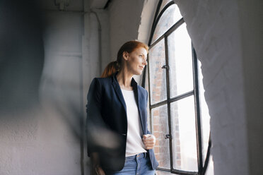 Businesswoman looking out of window - JOSF02993