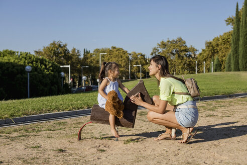 Happy mother with daughter on a playground - MAUF02407