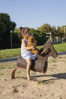 Little girl on rocking horse on a playground - MAUF02408