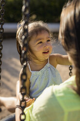 Portrait of a girl with her mother on a playground - MAUF02430