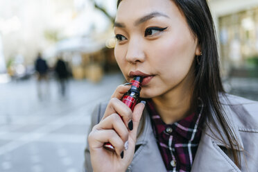 Young woman smoking electronic cigarette - KIJF02224