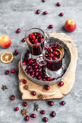 Two glasses of Mulled Wine with cranberries, orange slices and star anise on tray - SARF04056