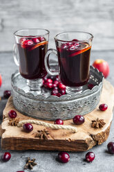 Two glasses of Mulled Wine with cranberries, orange slices and star anise on tray - SARF04057