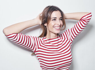 Portrait of laughing young woman wearing red-white striped shirt - PNEF01168