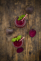 Two glasses of beet root smoothie garnished with basil leaves - LVF07689