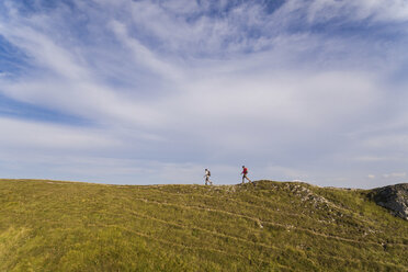 Italy, Monte Nerone, two men hiking on top of a mountain in summer - WPEF01296