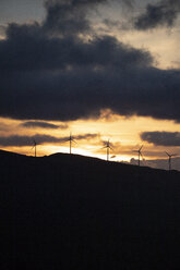 Spain, Andalusia, Tarifa, wind wheels on mountain at sunrise - KBF00460