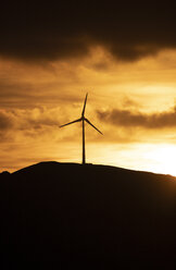 Spain, Andalusia, Tarifa, wind wheels on mountain at sunrise - KBF00462