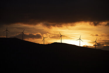 Spain, Andalusia, Tarifa, wind wheels on mountain at sunrise - KBF00463