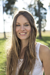 Portrait of smiling young woman in nature - PNEF01174