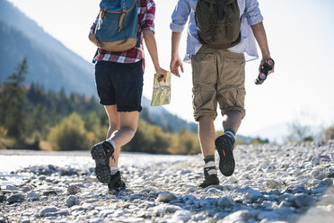 Austria, Alps, couple on a hiking trip with map and binoculars - UUF16528