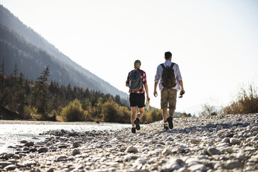 Austria, Alps, couple on a hiking trip with map and binoculars - UUF16530