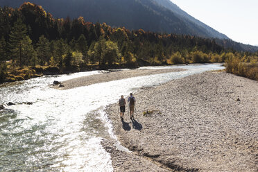 Austria, Alps, couple on a hiking trip walking along a brook - UUF16596