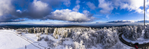 Germany, Hesse, Taunus, Aerial view of road through coniferous forest in winter stock photo