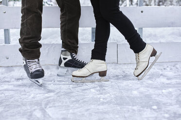 Couple standing at the ice rink - ZEDF01840