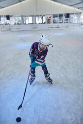 Boy playing ice hockey on the ice rink - ZEDF01862