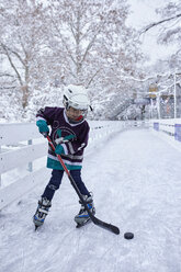 Boy playing ice hockey on the ice rink - ZEDF01869