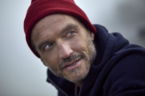 Portrait of bearded mature man wearing red cap outdoors - PNEF01183