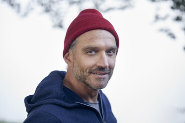Portrait of bearded mature man wearing red cap outdoors - PNEF01184
