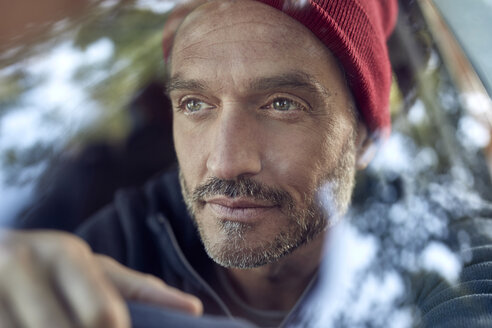 Portrait of bearded mature man behind windscreen - PNEF01192