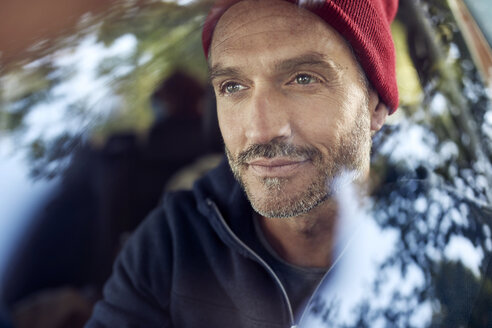 Portrait of bearded mature man behind windscreen - PNEF01193