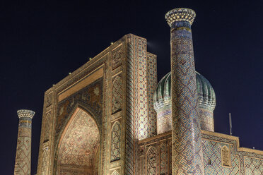 Historic 15th century Madrasa and courtyard, tall arch and minarets at night, Samarkand. - MINF10128