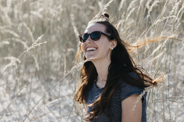 South Africa, Western Cape, Hout Bay, portrait of laughing young woman in the dunes - LHPF00399