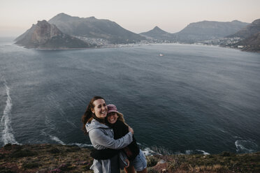 South Africa, Western Cape, two laughing women hugging each other - LHPF00416