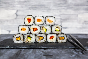 Stacked sushi on slate slab, chop sticks - SARF04070