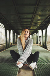 Portrait of young woman sitting in an abandoned train car - ACPF00404