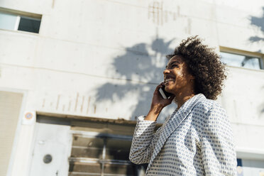 Beautiful woman walking in the city, talking on the phone - BOYF01317