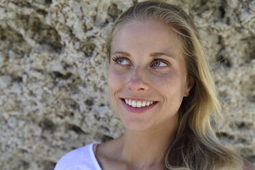 Portrait of smiling blond woman with rocky background - ECPF00312