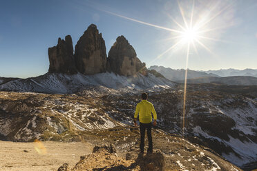 Italy, Tre Cime di Lavaredo, man hiking and standing in front of the majestic three peaks - WPEF01331